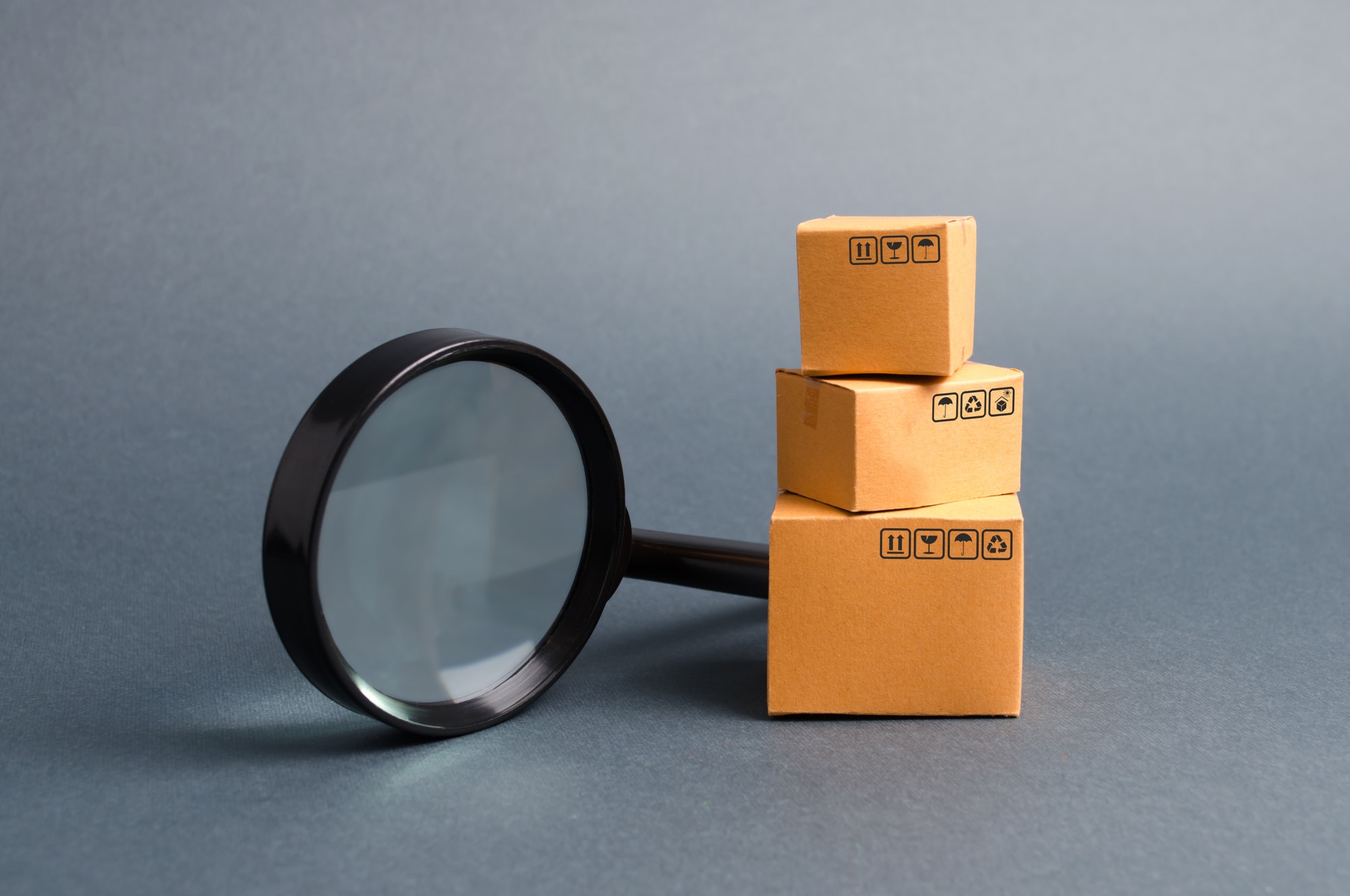 Cardboard boxes and a magnifying glass