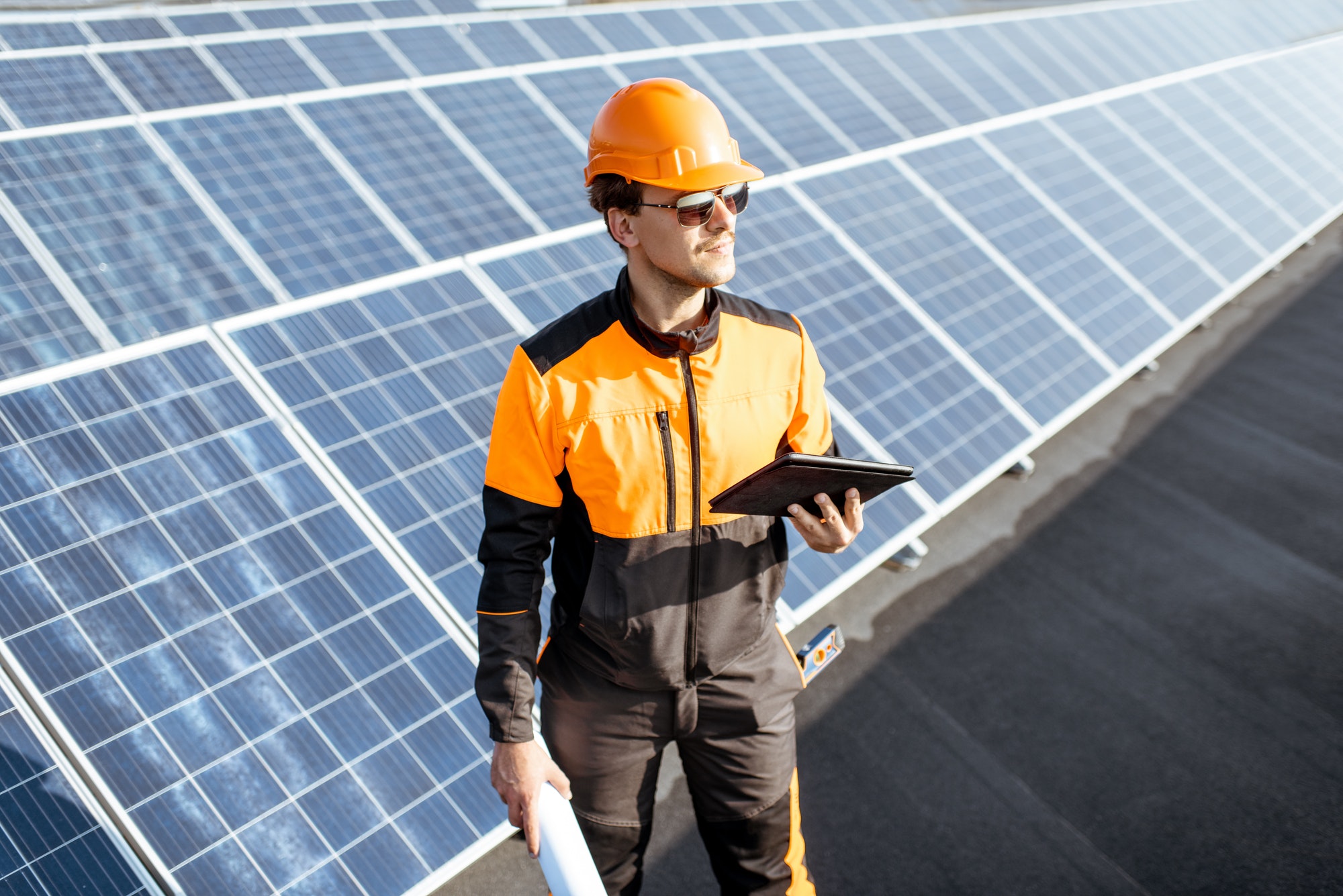 Engineer servicing solar panels on electric plant
